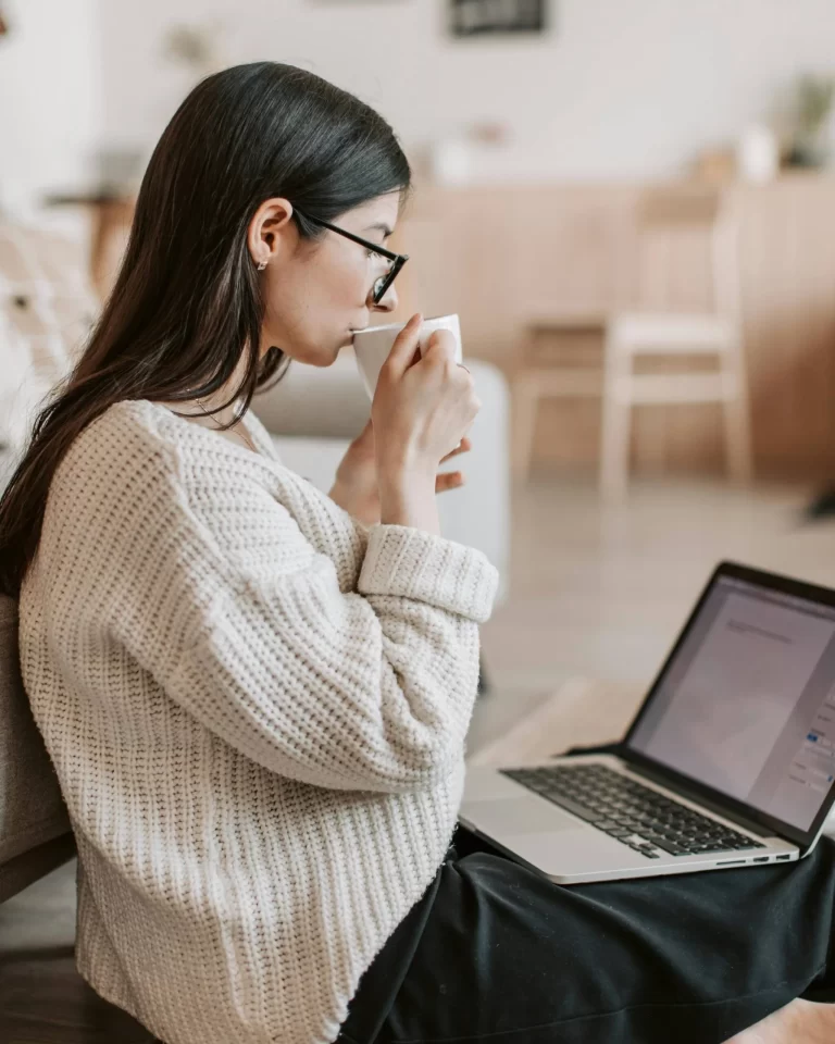 Woman preparing document on laptop